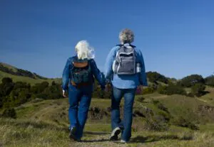 Errol and Rochelle Strider walking away in mountains