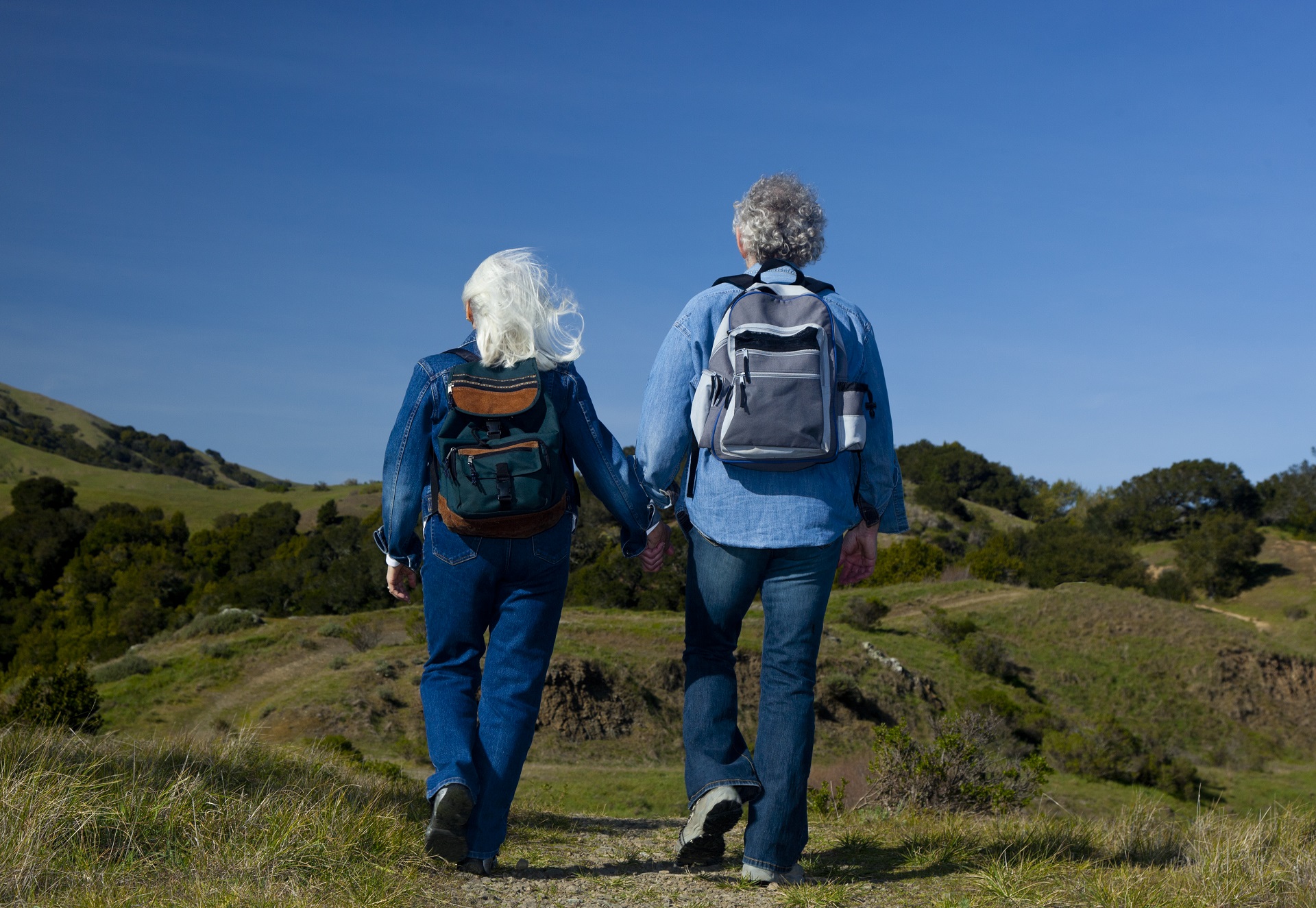 Errol and Rochelle Strider walking away in mountains